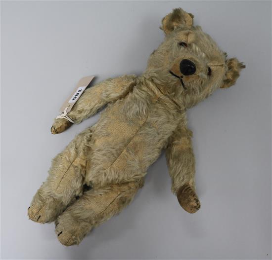 A plush covered articulated teddy bear